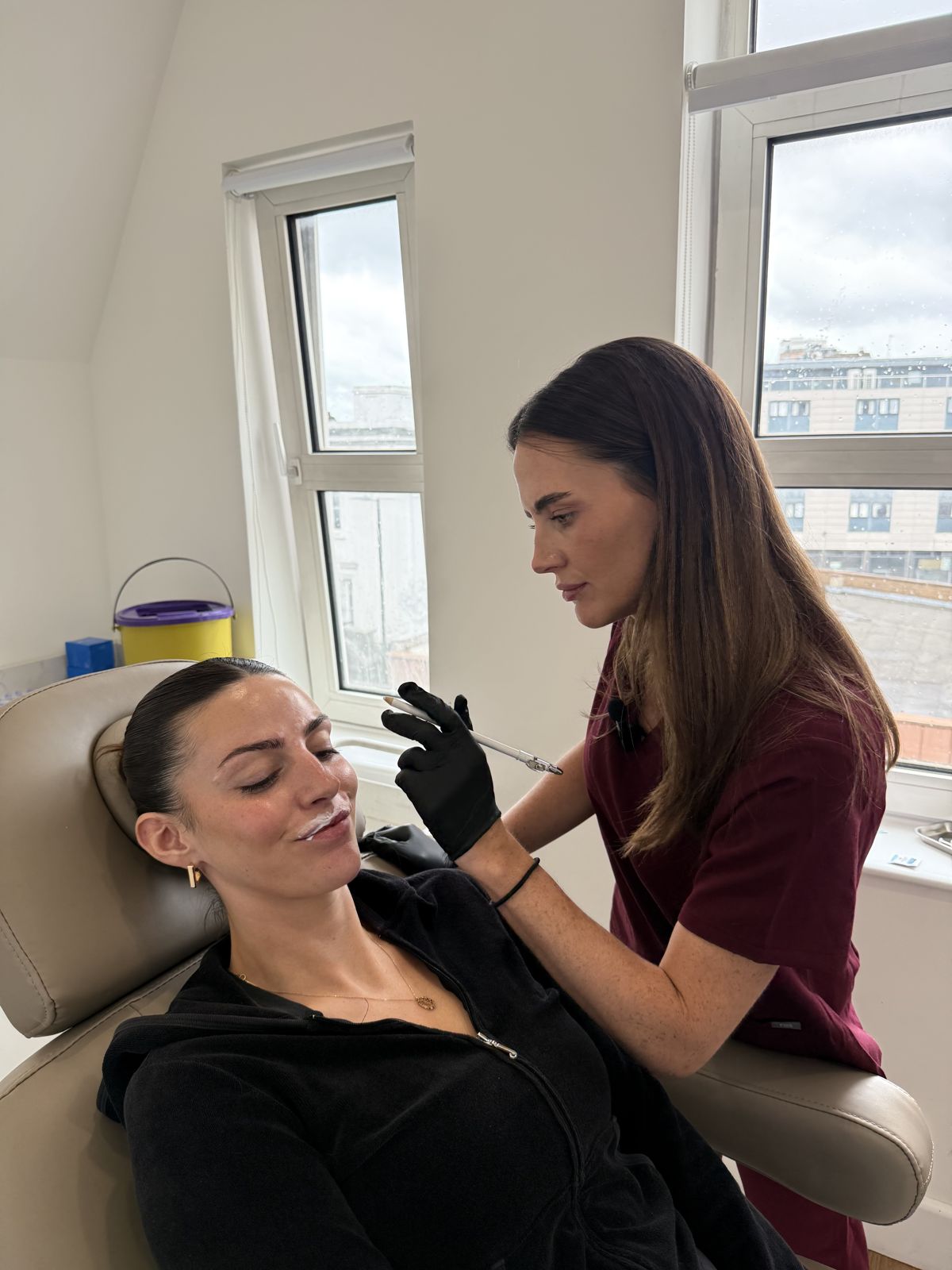 Lucy marking up a client before a lip treatment